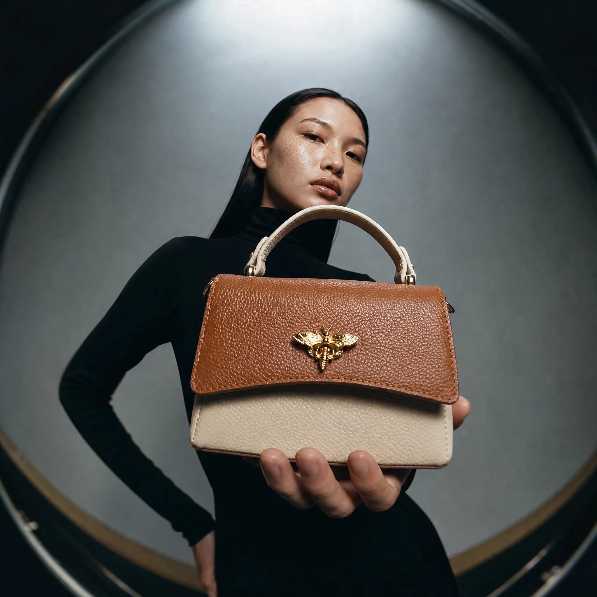 A woman holding a buterfly bag