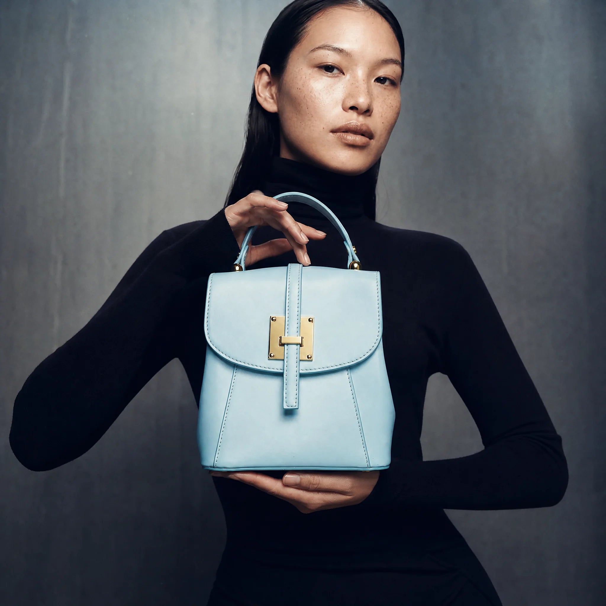 a woman holding a backpack