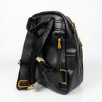 Black leather backpack with yellow zippers on a white background
